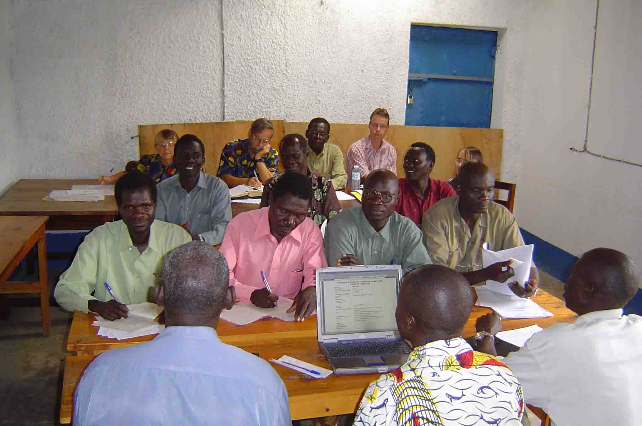 May, 2006: Consultants Joy and John Anderson (back row, left) work with the team to check 1-2 Timothy.